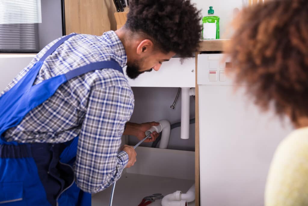 Plumber Cleaning Clogged Pipes