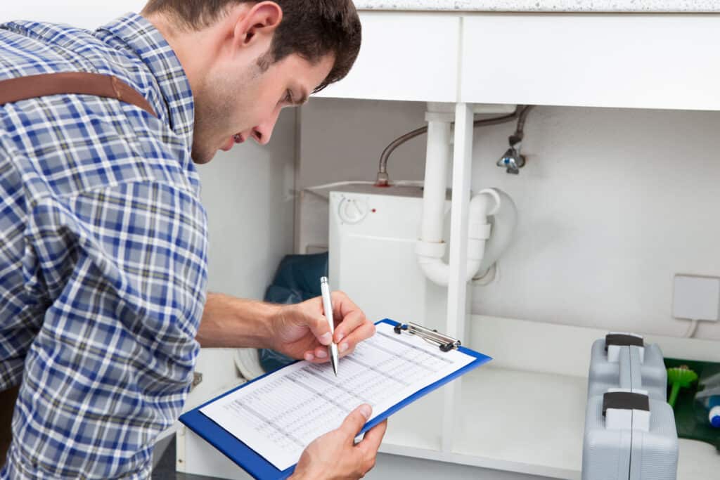 Plumber Writing On Clipboard