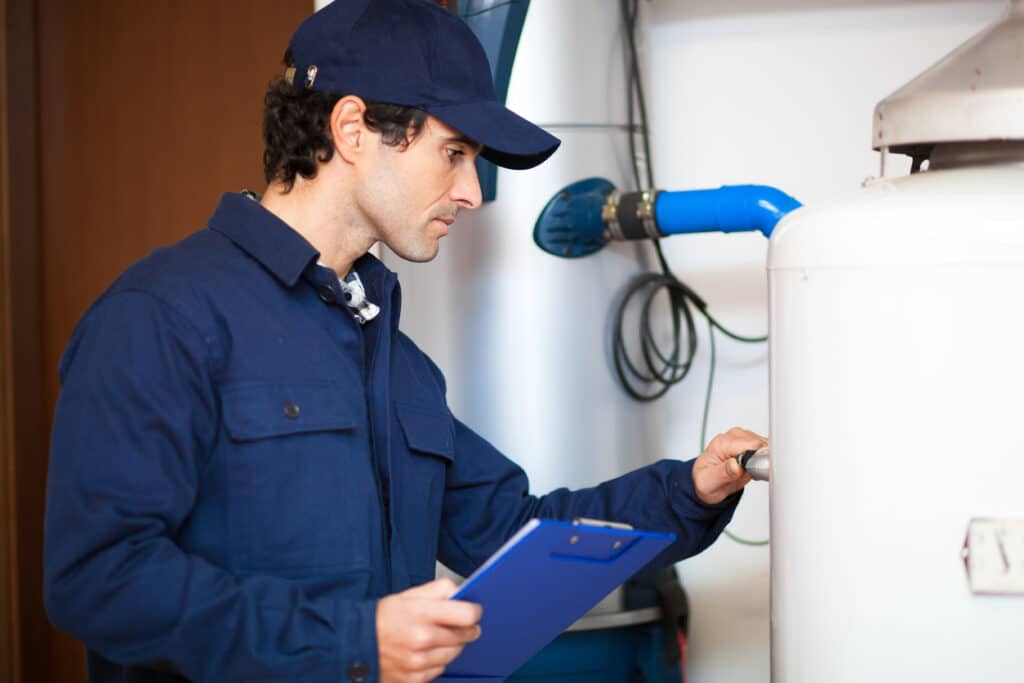 technician repairing hot-water heater