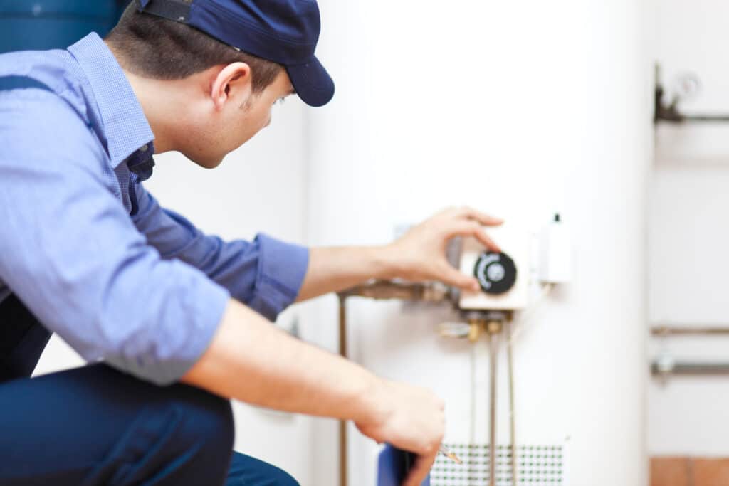 technician repairing an hot-water heater